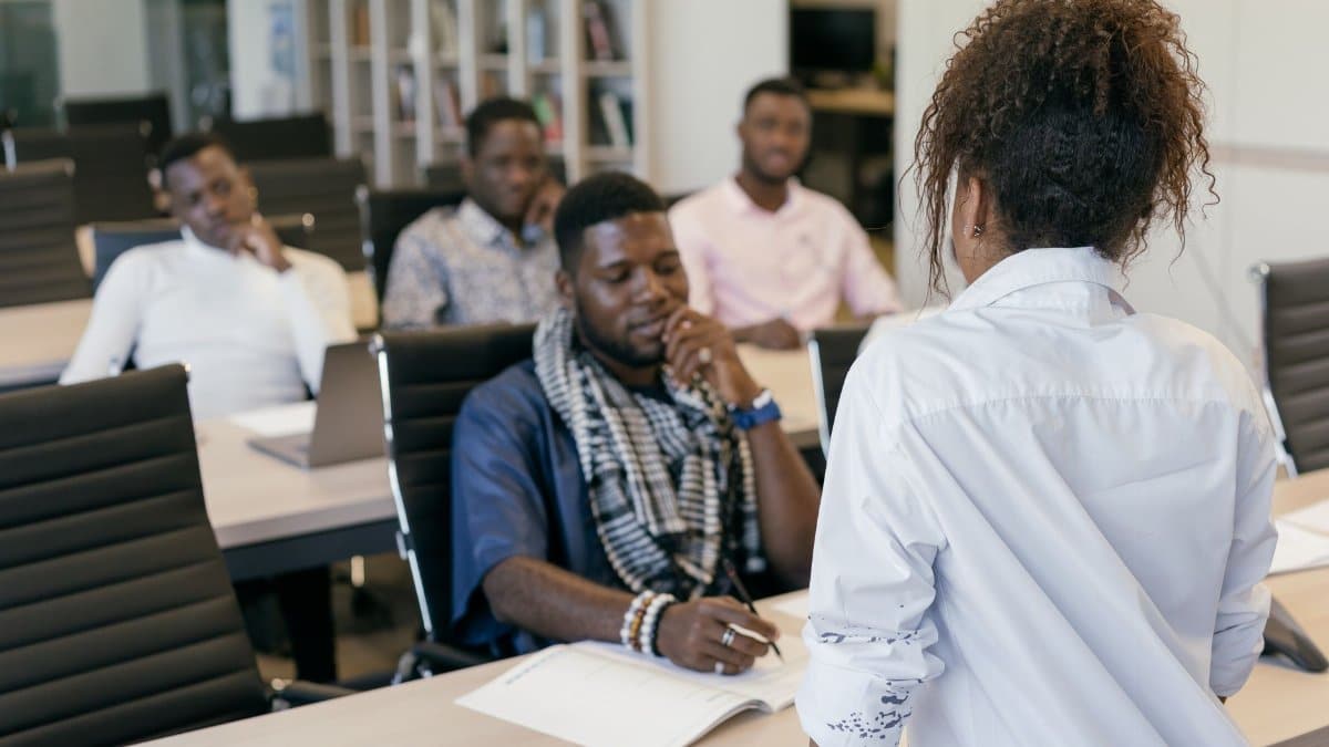 A group of professionals engaging in a training session in a modern office setting.