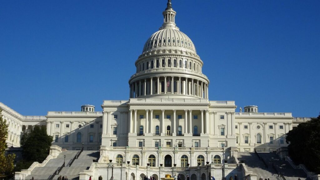 Stunning facade of the iconic United States Capitol in Washington D.C. against a clear blue sky.
