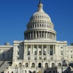 Stunning facade of the iconic United States Capitol in Washington D.C. against a clear blue sky.
