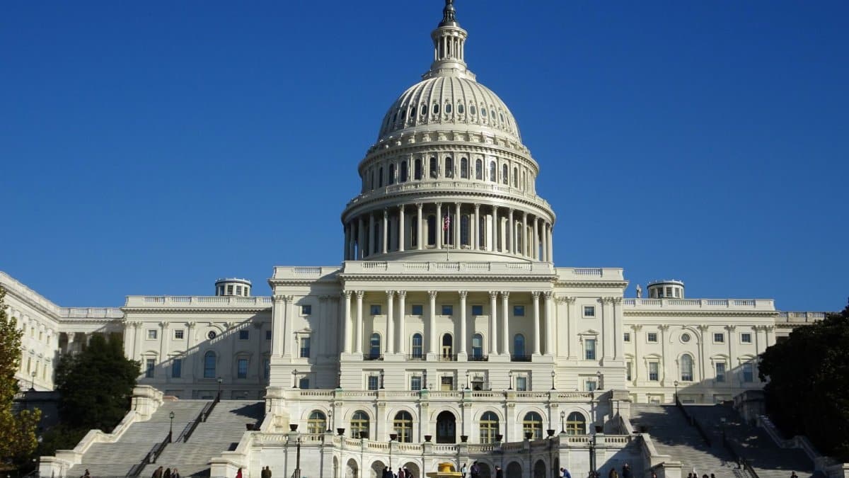 Stunning facade of the iconic United States Capitol in Washington D.C. against a clear blue sky.