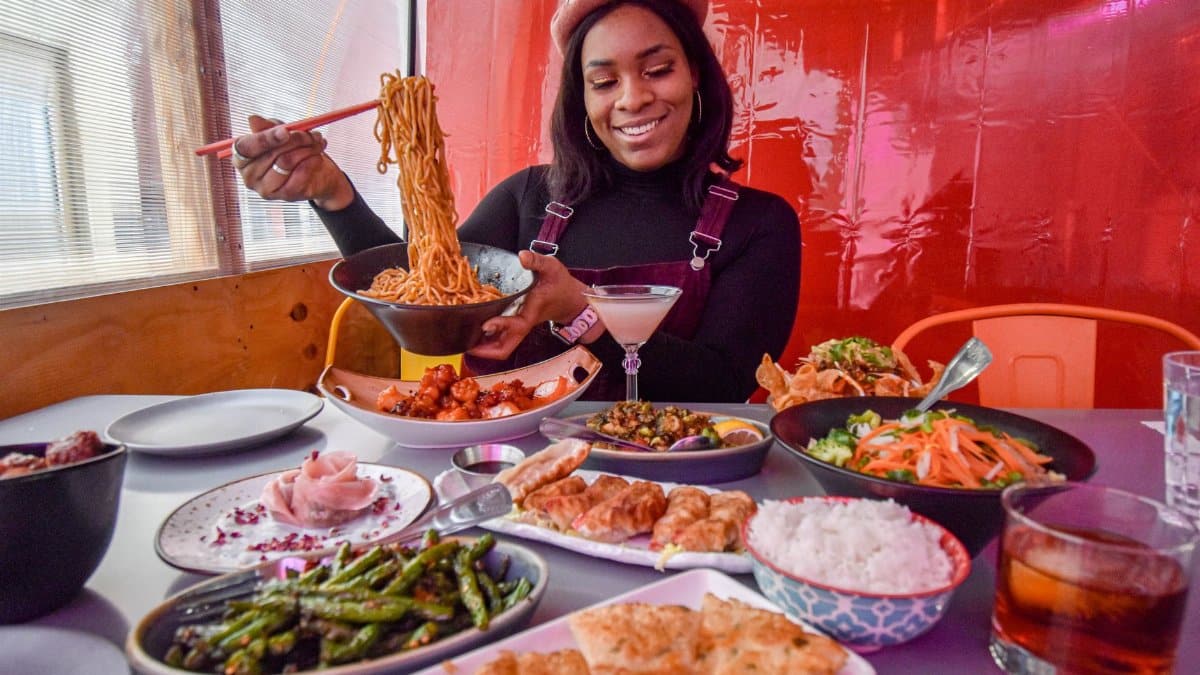 A woman savoring a delightful Asian cuisine meal at a New York City restaurant.