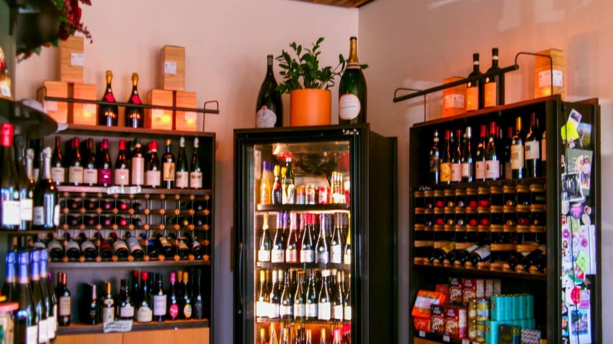 Vibrant wine shop interior showcasing assorted wine bottles on shelves.