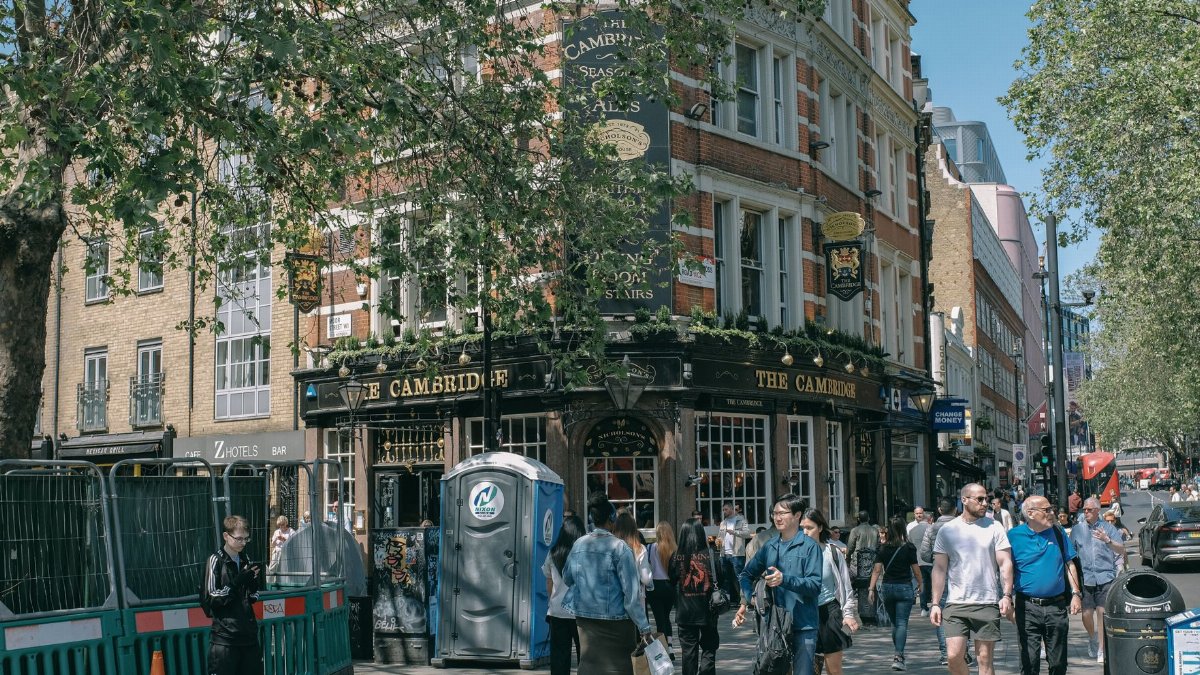 A bustling street scene outside the historic Cambridge pub in London.