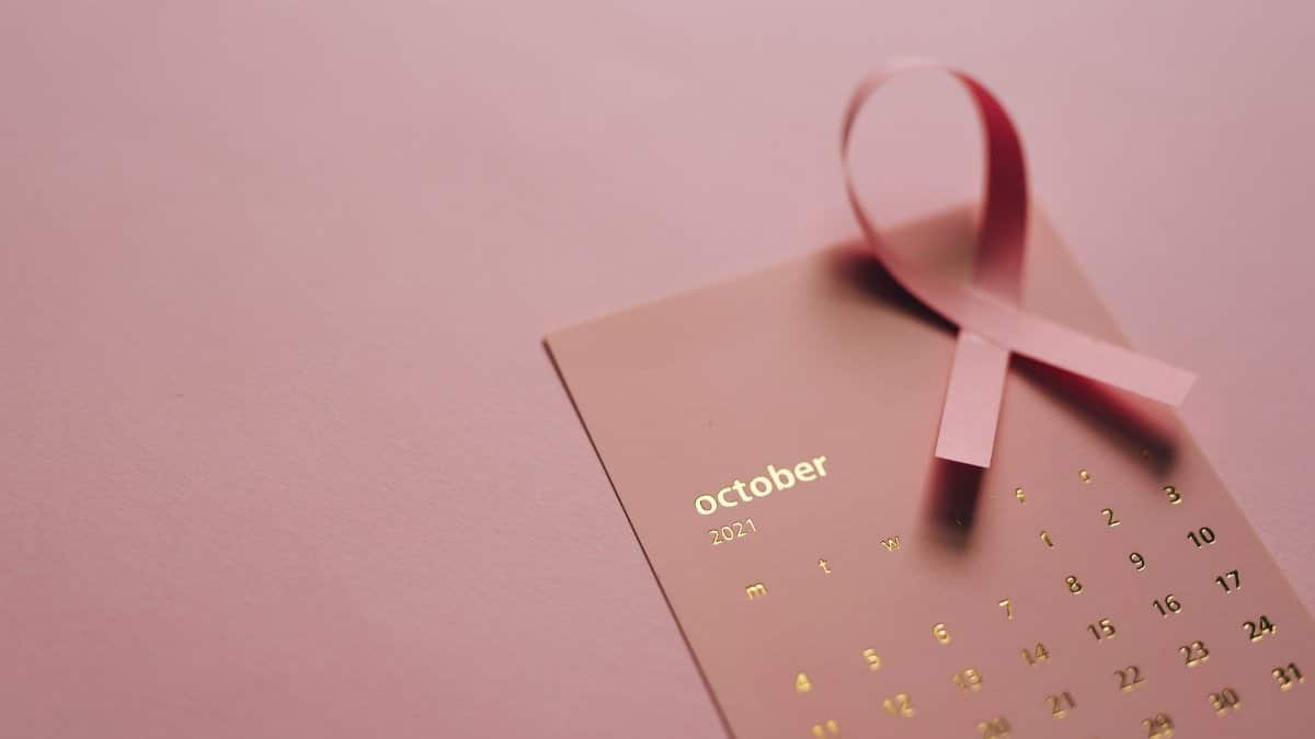 Pink ribbon on October 2021 calendar symbolizing breast cancer awareness.