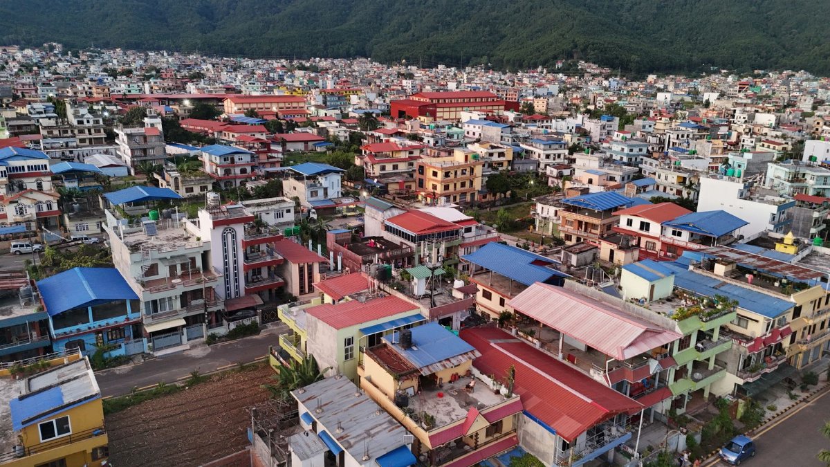 Colorful aerial view of a vibrant city with distant mountains in Nepal.
