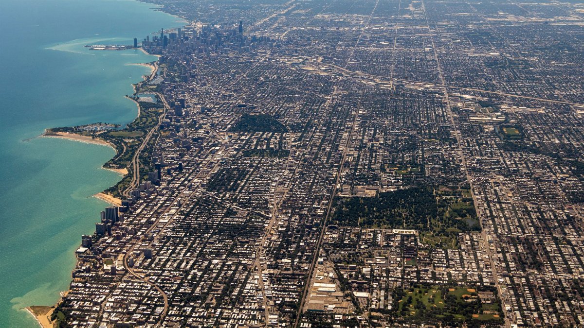 Stunning aerial panorama of Chicago revealing the city skyline, Lake Michigan, and urban sprawl.