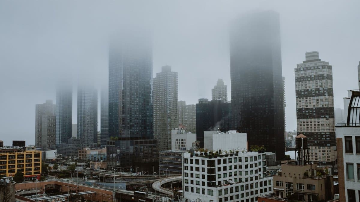 A misty view of New York City's skyscrapers enveloped in fog.