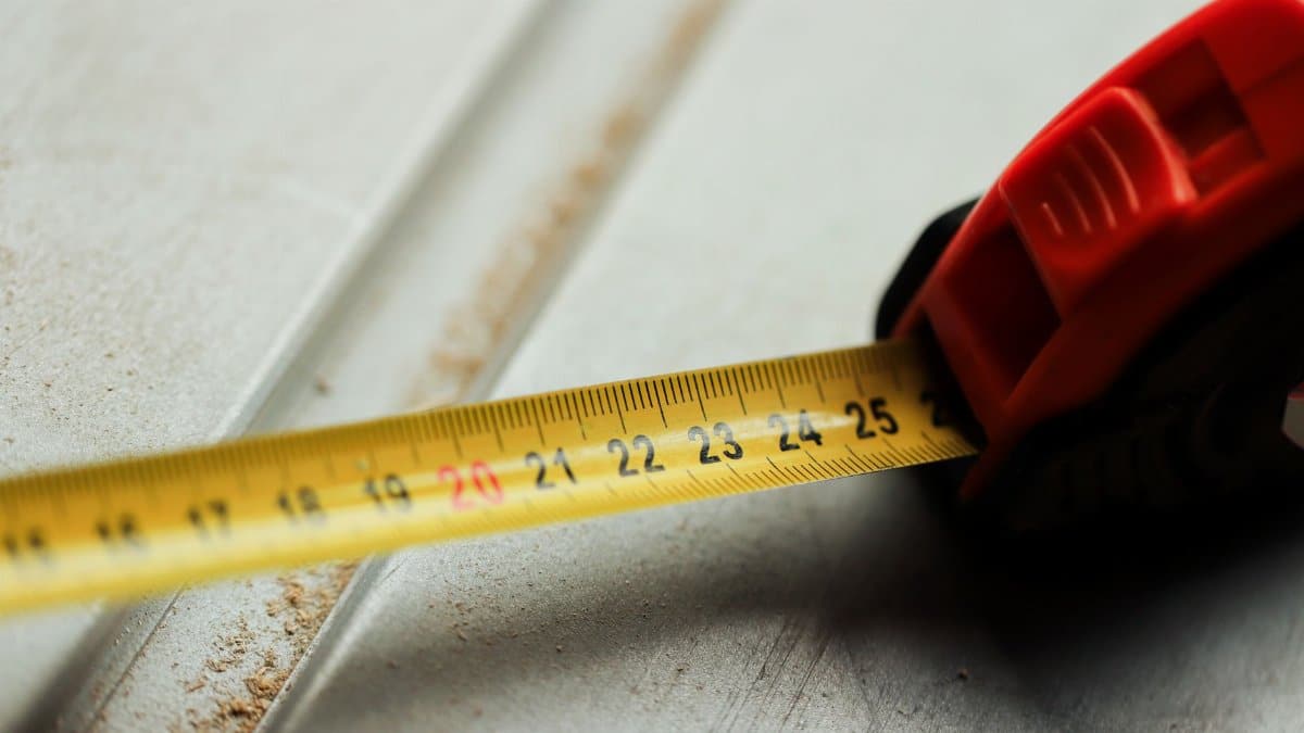 Detailed view of a tape measure on a construction surface, highlighting measurement accuracy.