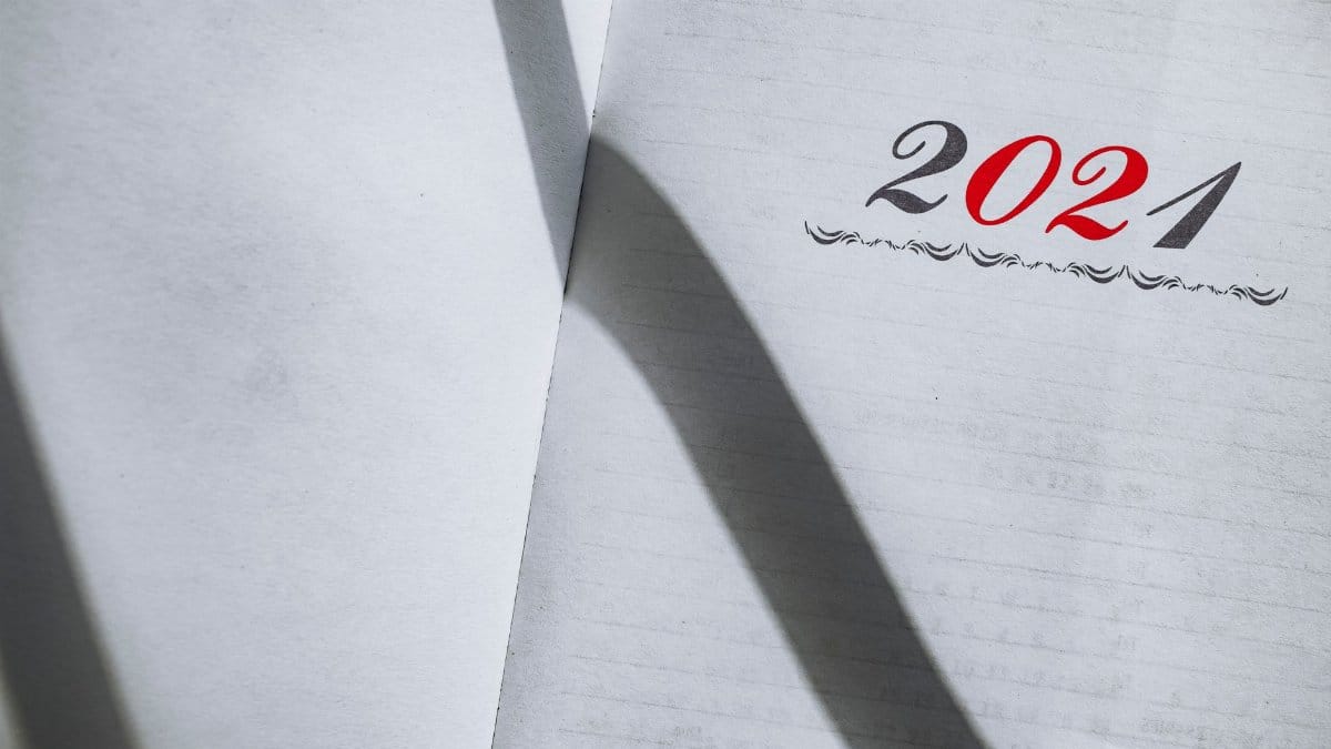 Close-up of an open planner showing the year 2021 with minimalist styling and shadows.