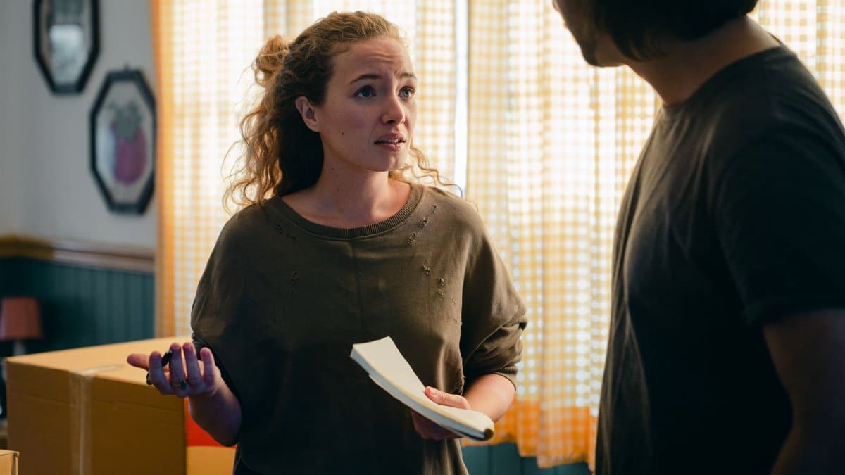 Young couple having argument about packing things in room with cardboard boxes while moving to new place