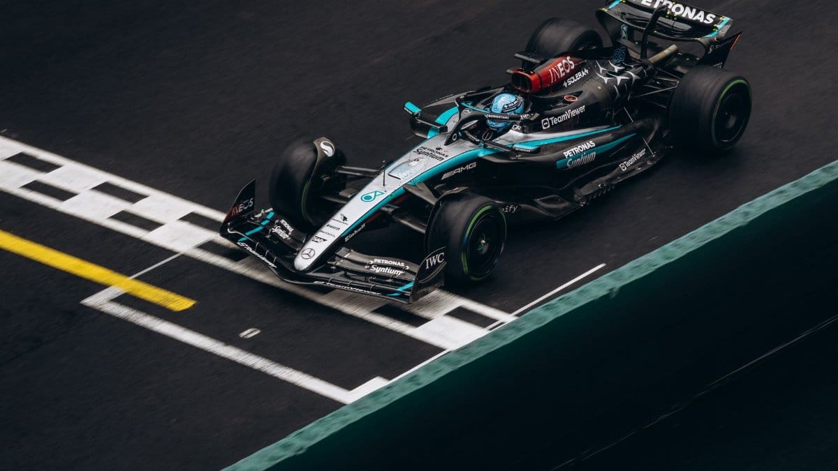 Top view of a Formula One car crossing the finish line in a high-speed race.