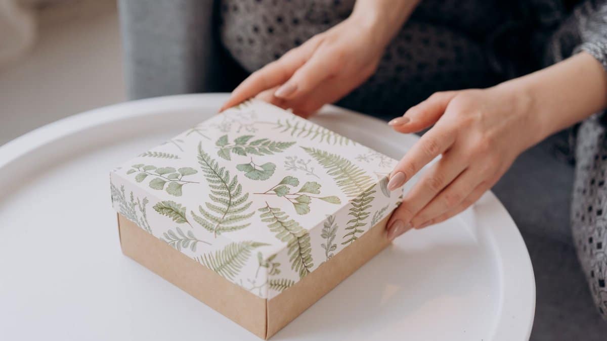 A beautifully wrapped gift box decorated with botanical patterns, perfect for special occasions.