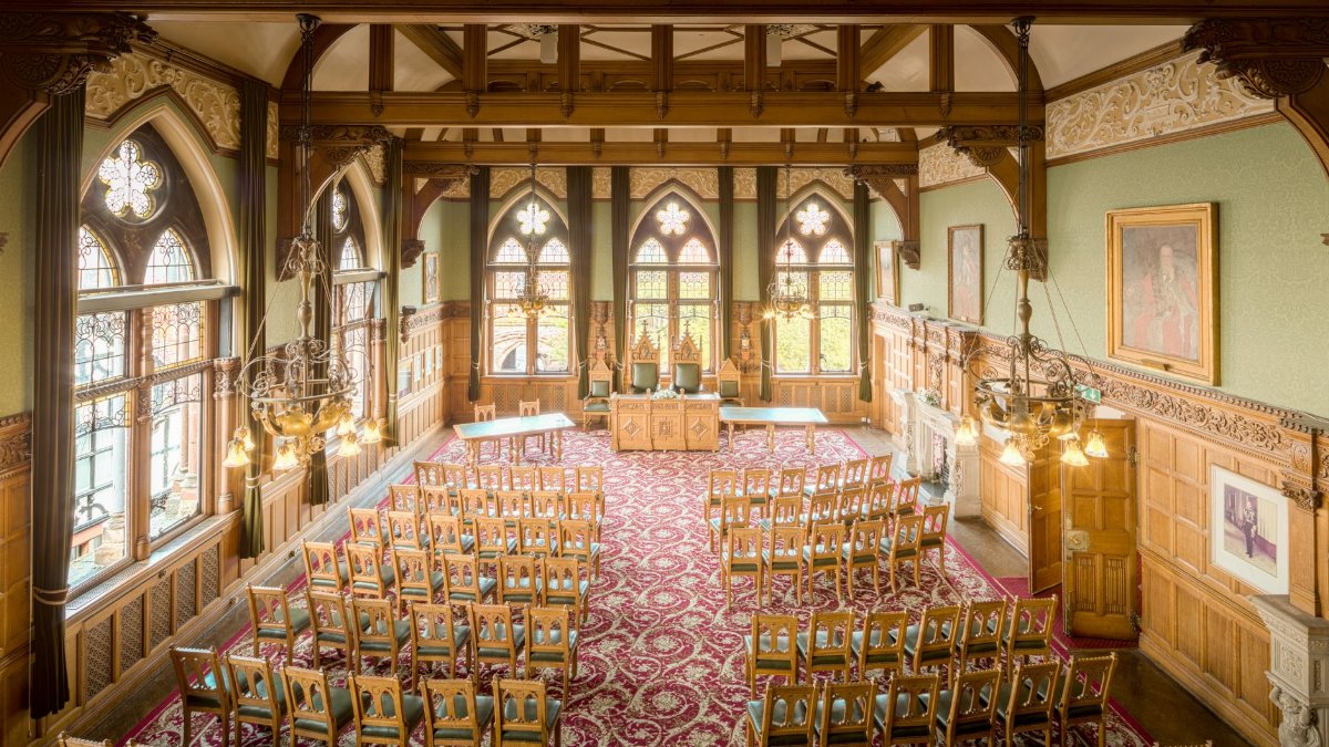A beautifully ornate town hall interior featuring vintage woodwork and impressive Gothic architecture.