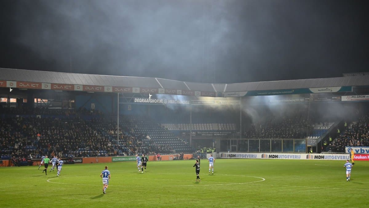 Football match under stadium lights, capturing the dynamic atmosphere and player action.
