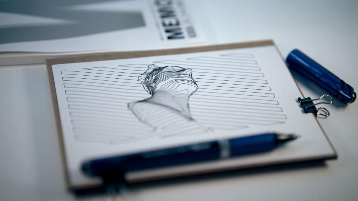 Creative abstract line drawing of a face in close-up with pen and clipboard.