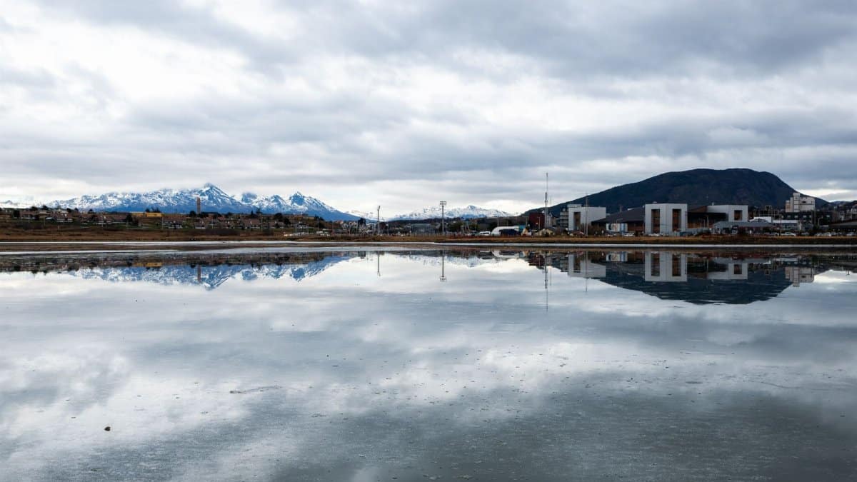 A stunning view of snowcapped mountains reflecting in the water in Ushuaia, Argentina.