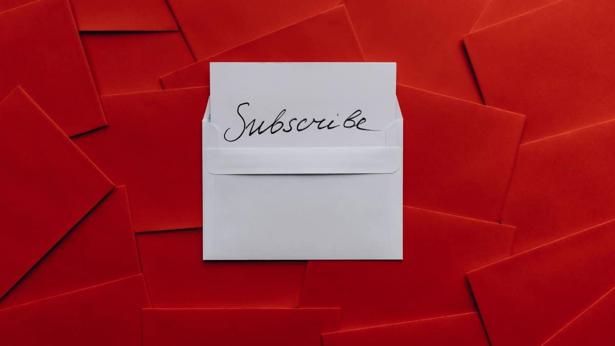 A collection of red envelopes with a central white envelope containing a subscribe card. Perfect for marketing themes.
