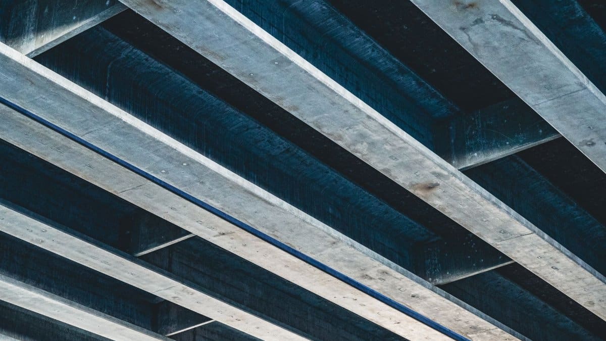 Low angle shot of an industrial steel and concrete ceiling structure.