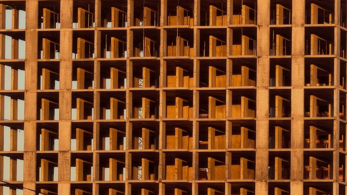 Close-up of an unfinished building facade during sunset with warm lighting.