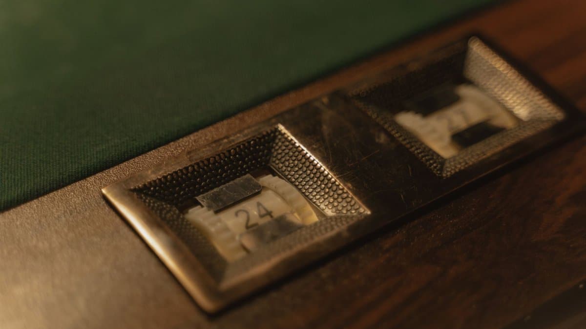 Detailed shot of a vintage pool table score counter with numbers in focus.