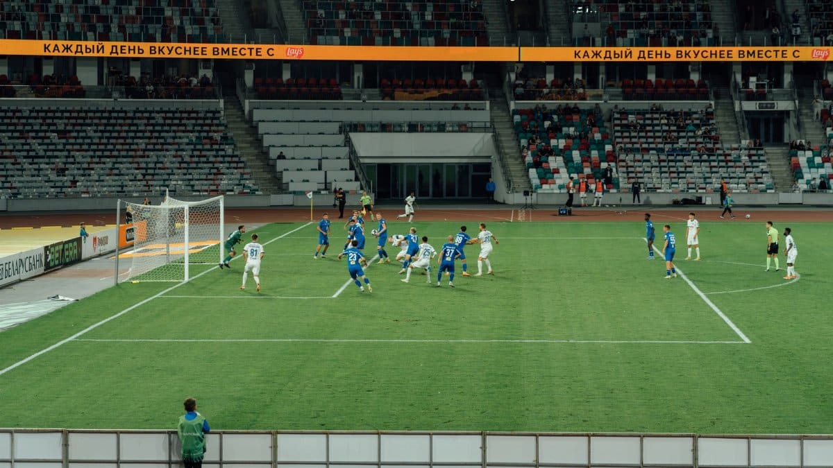 A thrilling football game captured in a large, modern stadium at night.