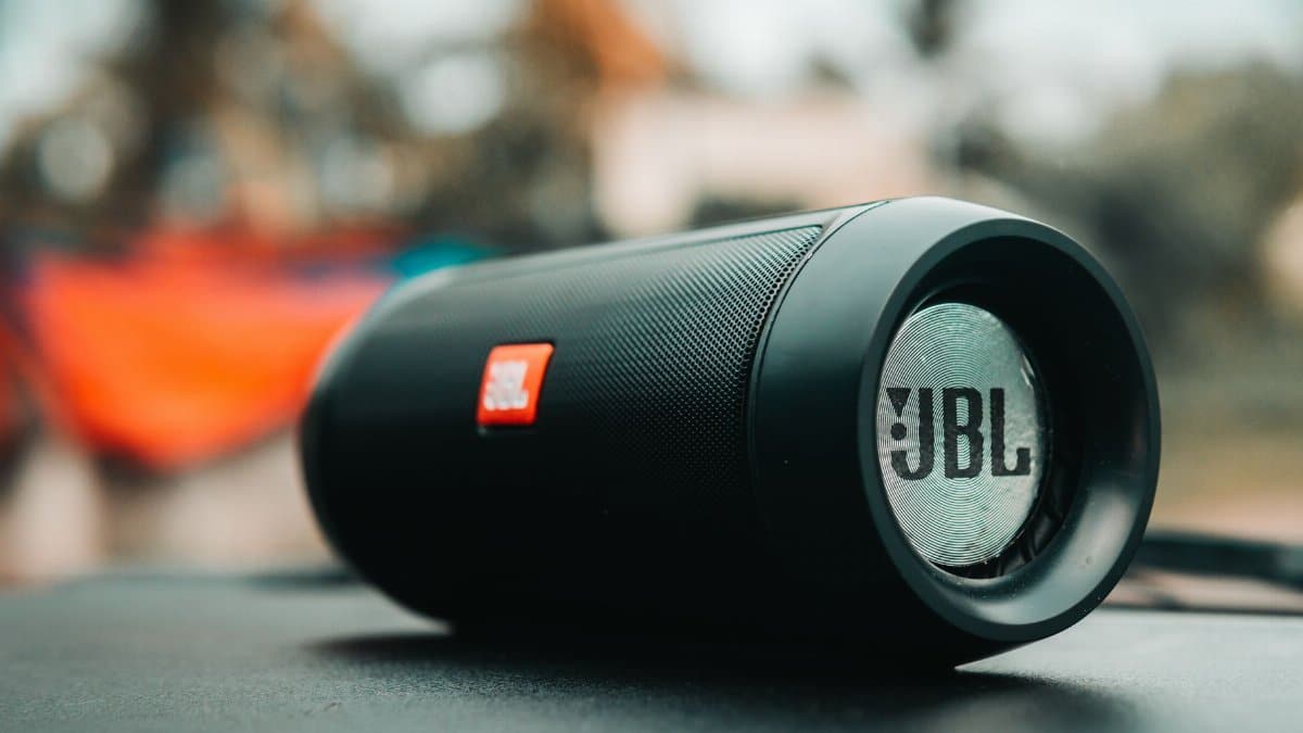 Focused shot of a black JBL portable speaker on a surface, ideal for technology concepts.