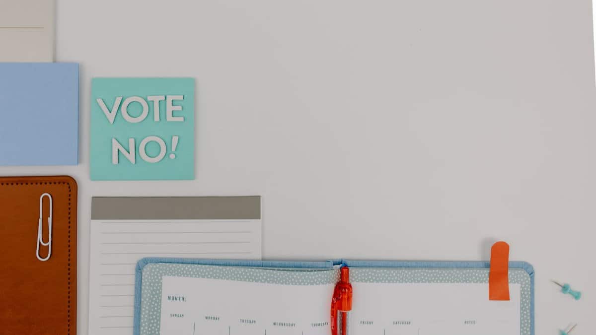 Creative flat lay with a notepad and 'Vote No' message. Ideal for organizational or political concepts.