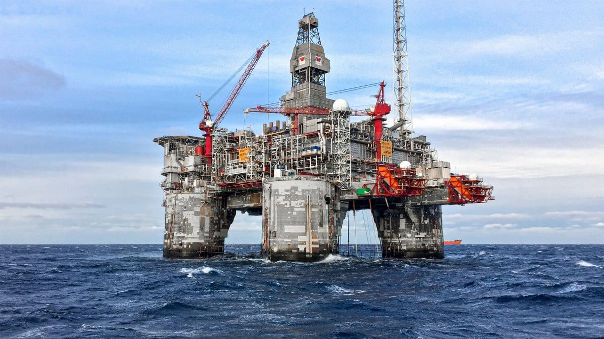 An offshore oil platform in Norway's North Sea under a clear blue sky.
