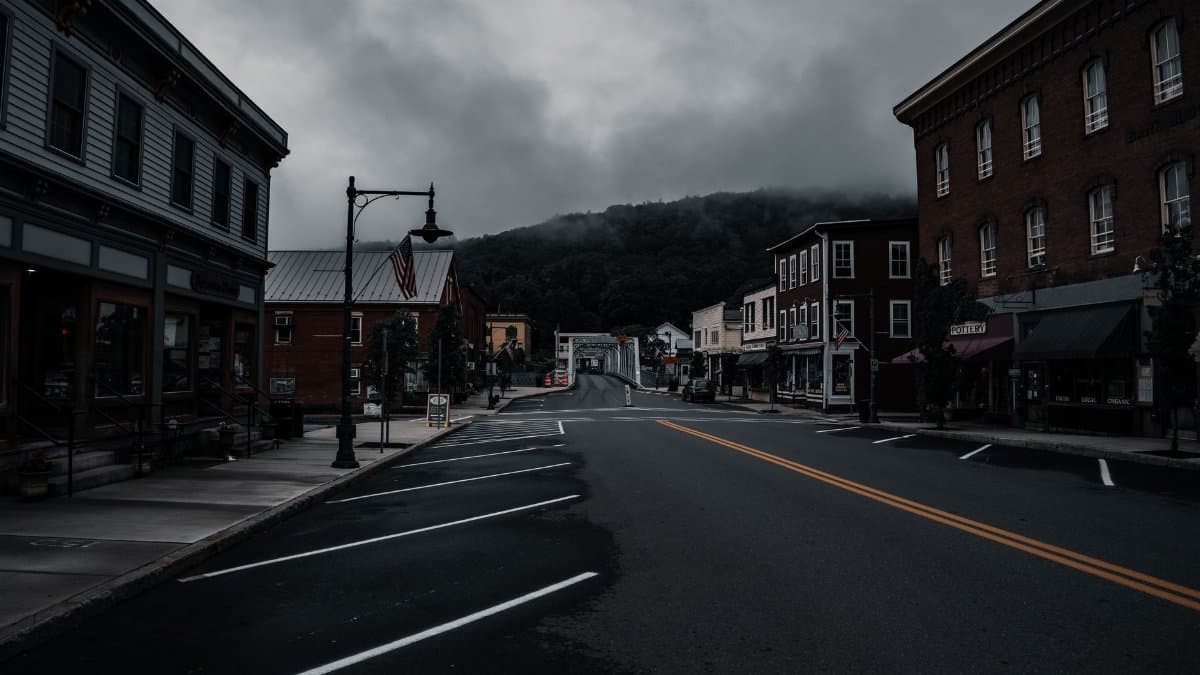 Empty town street with historic buildings and moody clouds. Perfect for travel or urban exploration themes.