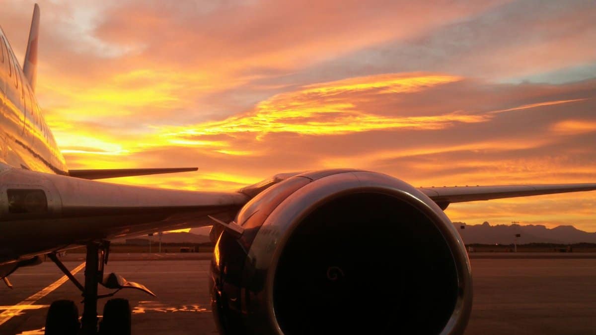 Stunning view of an airplane turbine with a vibrant sunset sky at Cape Town airport.