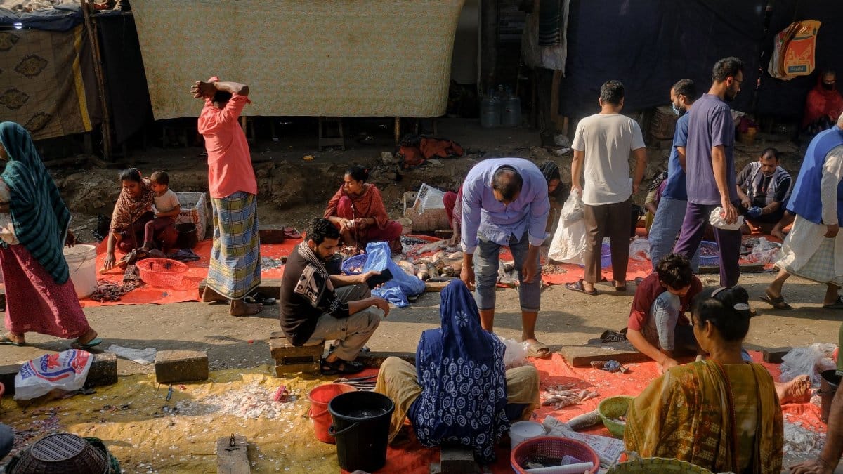 Vibrant marketplace with people engaging in trade and social interaction under the sun.