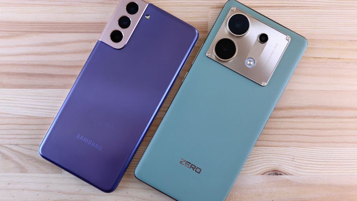 Two smartphones on a wooden surface, showcasing sleek design and modern technology.
