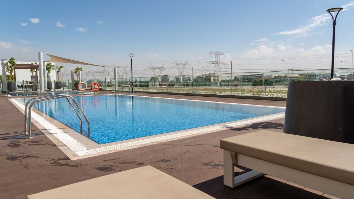 Inviting rooftop pool with Dubai skyline backdrop, perfect for relaxation and luxury living.