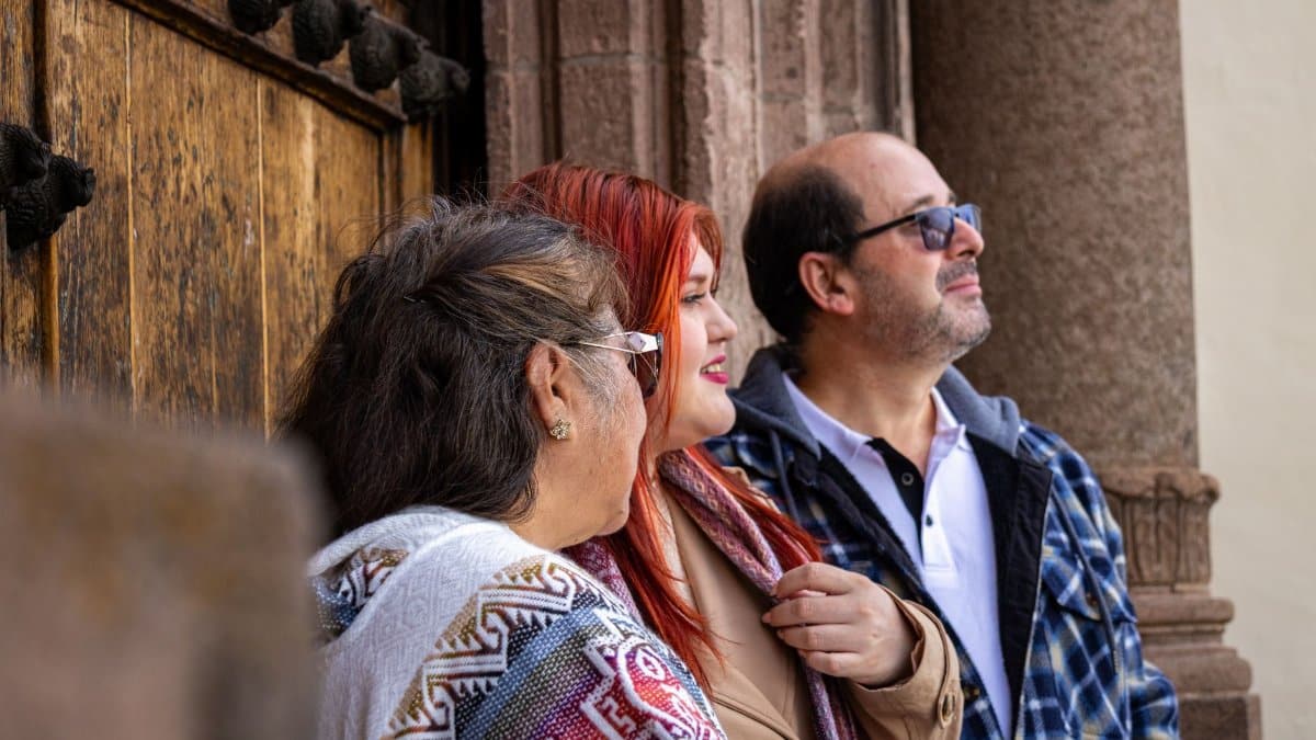 Three adults appreciating urban architecture, captured together in an outdoor setting with stone and wood elements.