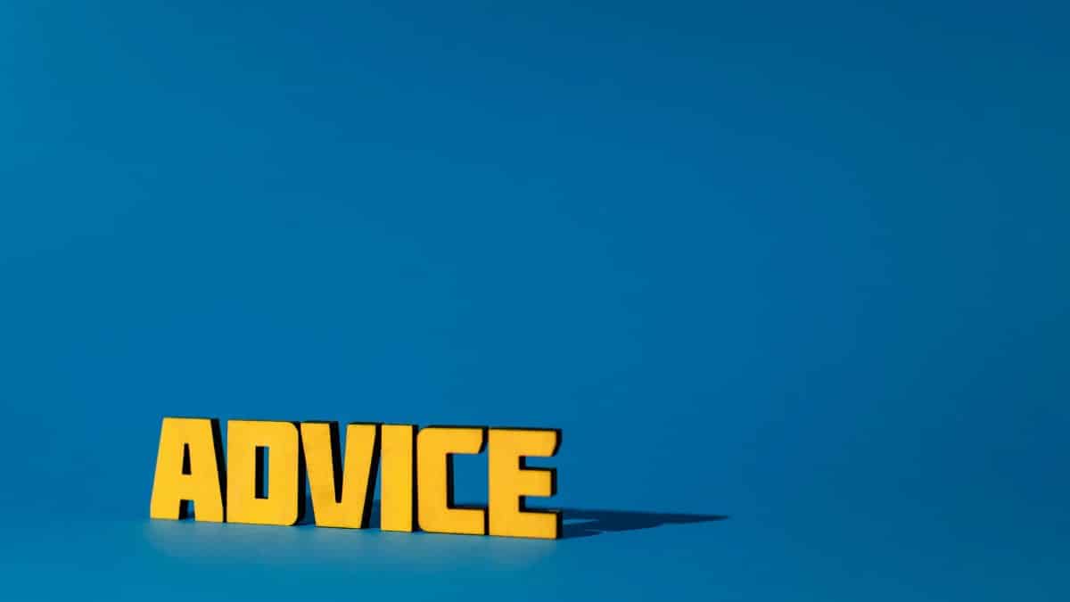 Yellow letters spelling 'Advice' on a vibrant blue background with ample copy space.