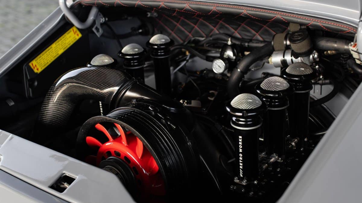 Close-up view of a high-performance engine with carbon fiber and chrome components.