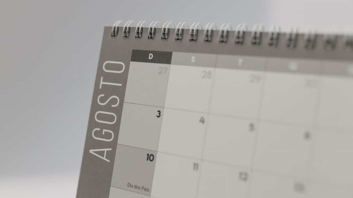 Detailed close-up of a spiral-bound calendar displaying the month of August.