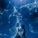 A robotic hand reaching into a digital network on a blue background, symbolizing AI technology.