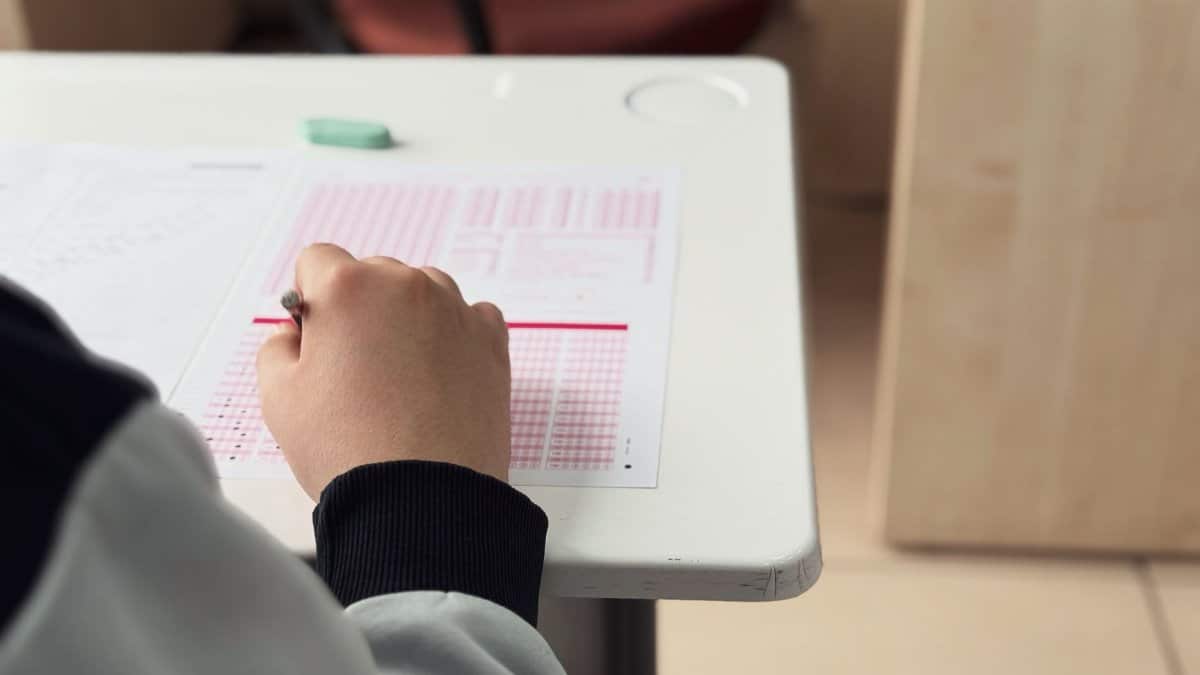 Close-up of student answering a test in a classroom environment.