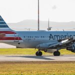 American Airlines airplane on the tarmac during daylight, featuring bright colors and clear aviation details.