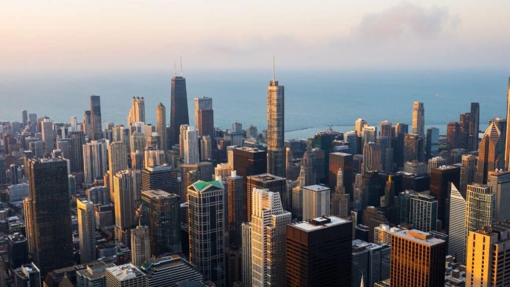 Stunning aerial view of the Chicago skyline with Lake Michigan in the background during sunset.