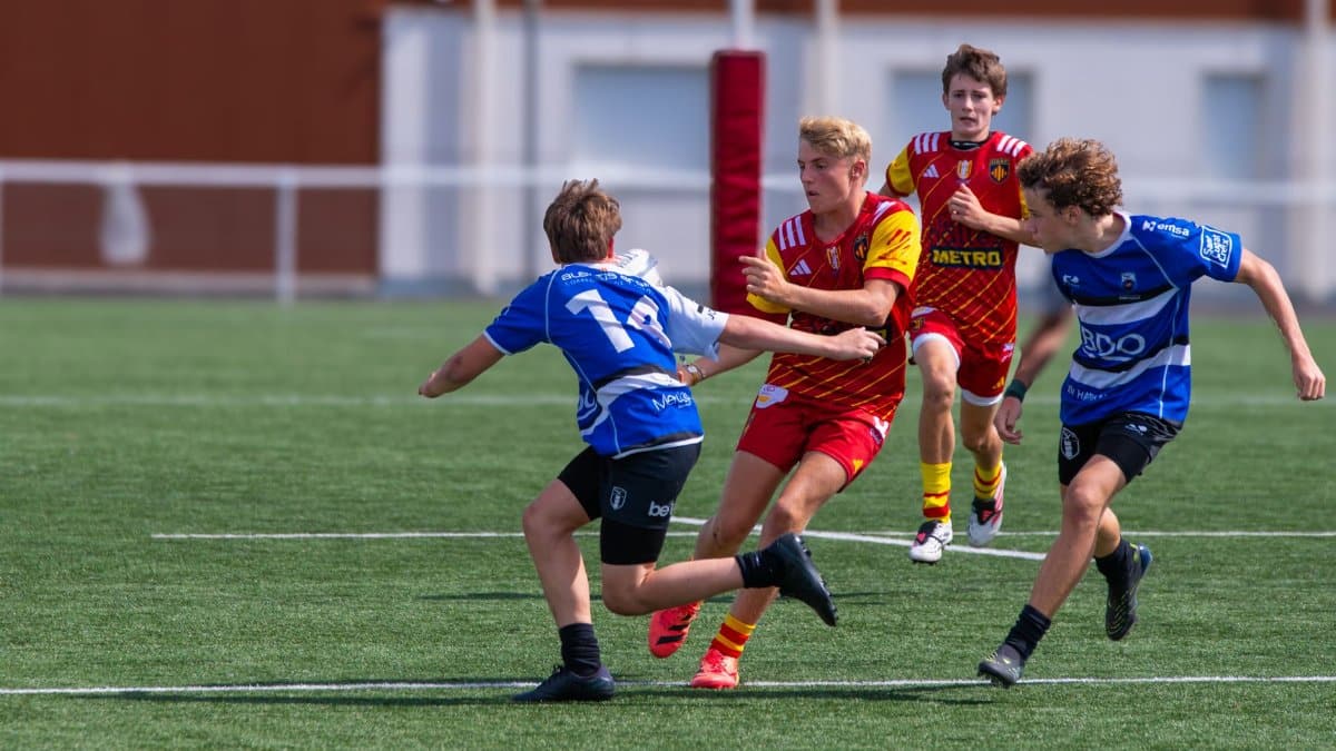 Energetic rugby scene with teenage players competing in a match outdoors.