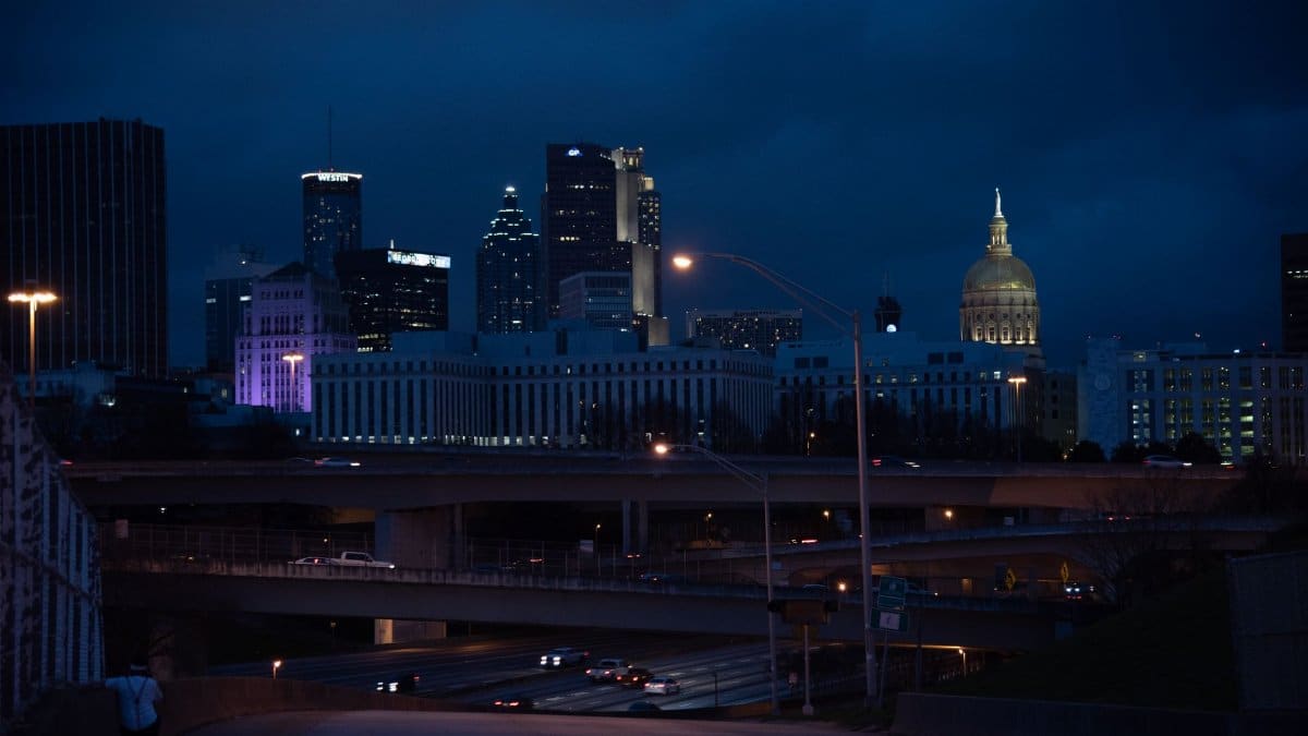A captivating view of Atlanta's skyline with illuminated buildings and highways at night.