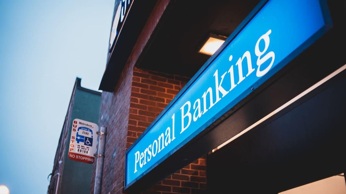 From below of bright blue signboard saying personal banking on modern building of town