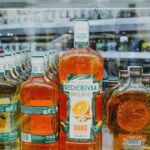 An array of vibrant liquor bottles displayed in a store showcase highlighting various spirits.