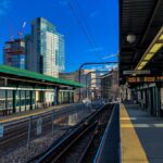 Captured at Boston's train station, showcasing the urban landscape and clear blue sky.