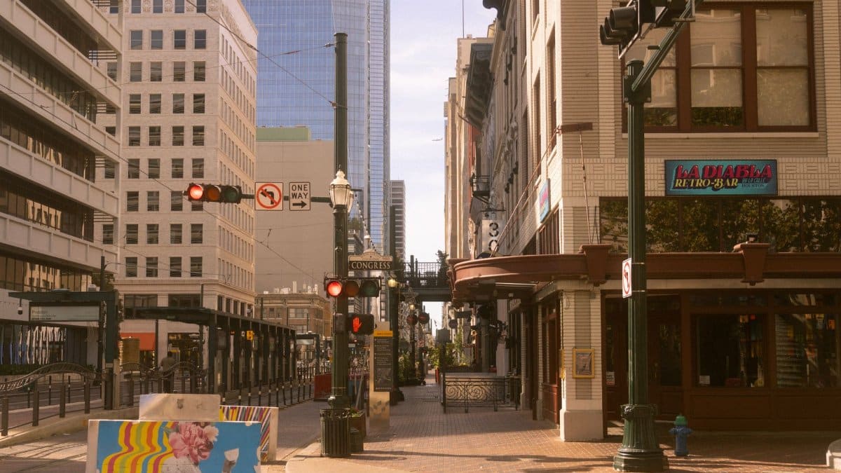 A vibrant corner in downtown Houston featuring street art and historic architecture.