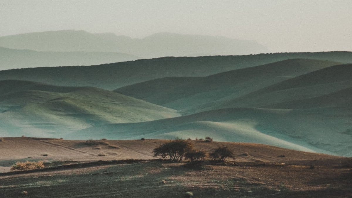 Peaceful Moroccan hills creating a layered landscape with soft lighting.