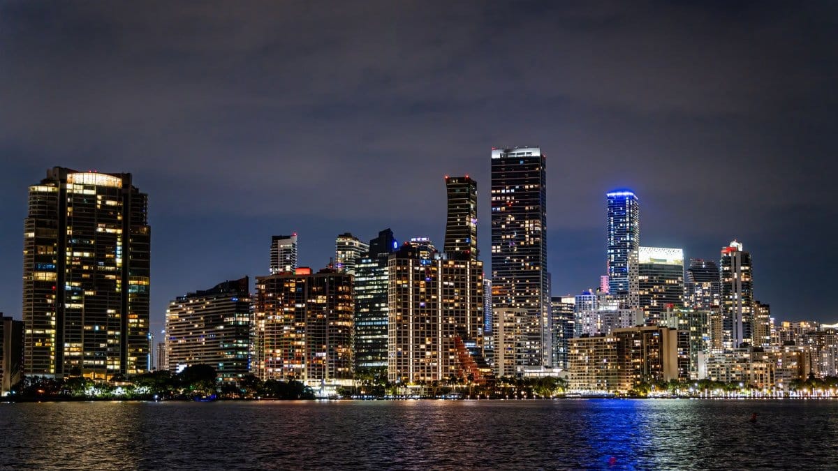 Captivating view of Miami's illuminated skyline at night, showcasing its modern architecture and vibrant city life.