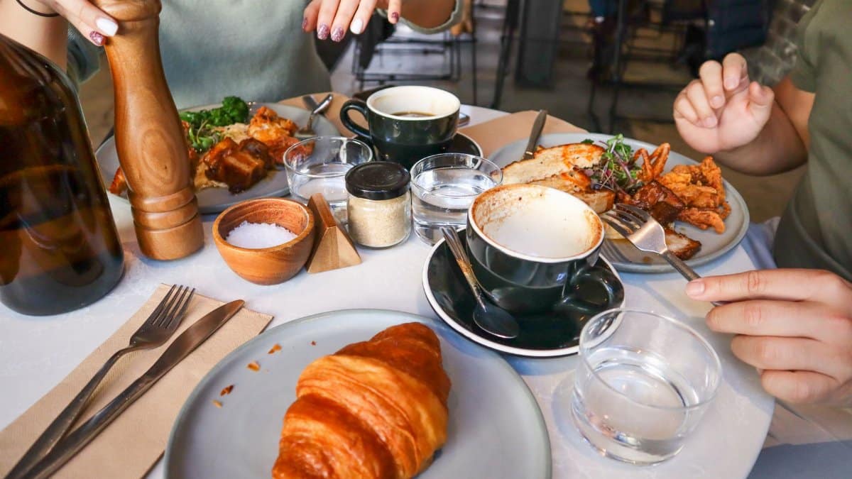 Casual brunch scene with croissants and coffee, ideal for food and lifestyle themes.